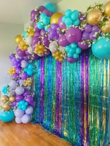 Custom Balloon Install with dark purple, light purple, turquoise, and gold.